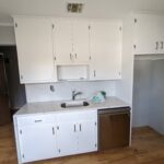 white storage pantry cabinets with chrome fixtures