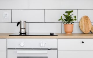 Enlarge subway tile backsplash and white minimalist appliances and white cabinetry