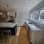 Remodeled modern kitchen with white countertops and stainless steel appliances