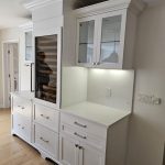 modern white cabinetry in remolded kitchen with integrated wine chiller